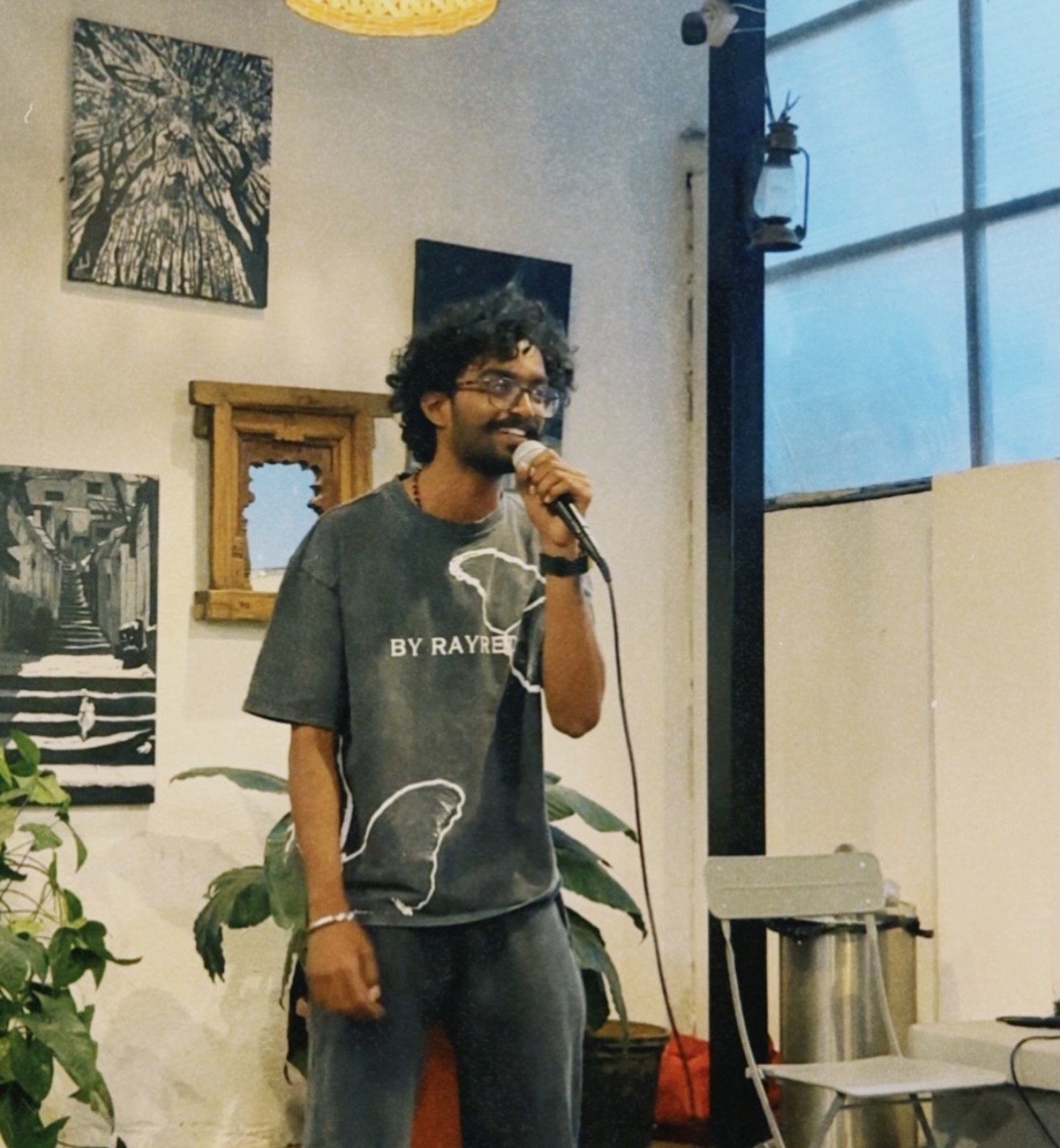 Musician mid-sentence, smiling, holding a guitar